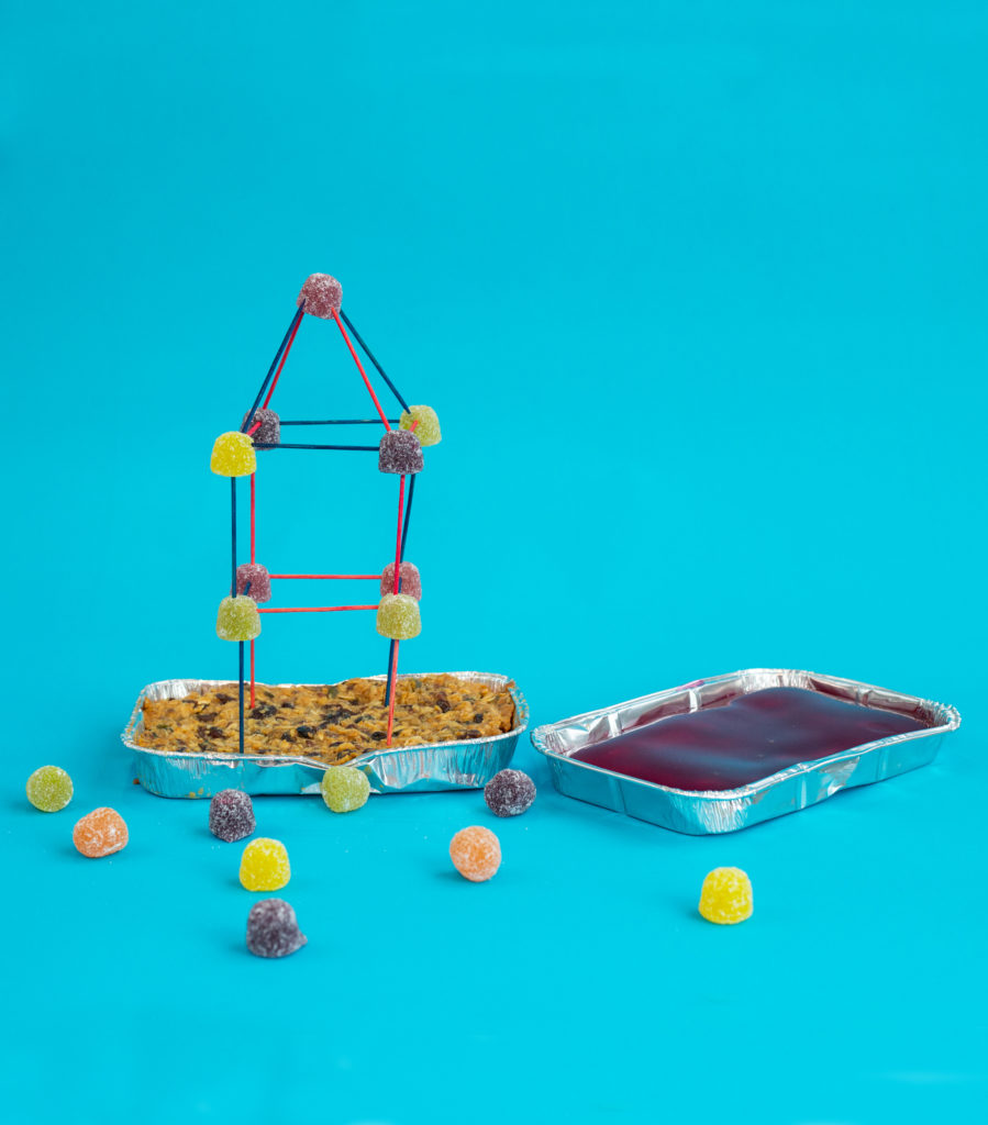 Tower made from gummy sweets and toothpicks in a flapjack foundation ready for an earthquake investigation
