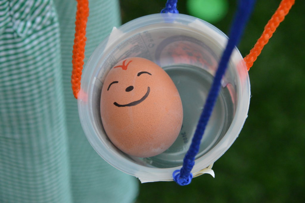 egg inside a homemade parachute. Fun STEM Challenge for kids