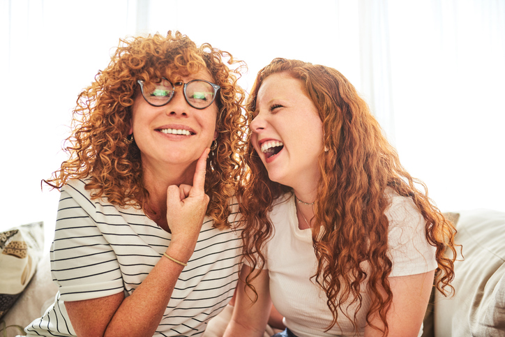 two redheads with curly hair