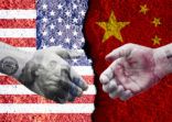 US dollar and China Yuan banknote print screen on handshake with both flags countries.It is symbol of economic tariffs trade war and tax barrier between United States of America and China.